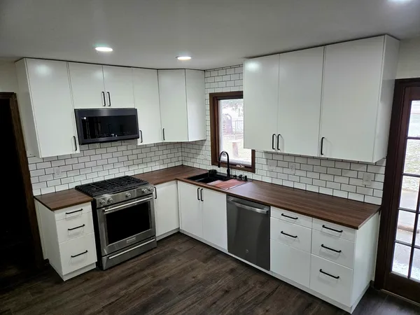 a kitchen with stainless steel appliances granite countertop a stove and a sink