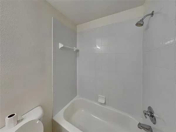a bathroom with a bathtub and toilet