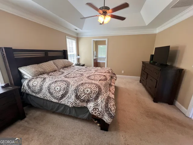 a bedroom with a bed and dresser