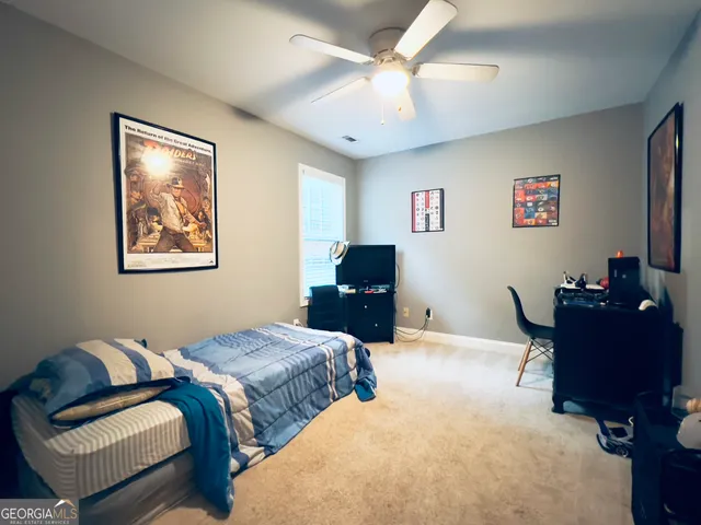 a bedroom with two beds and a desk