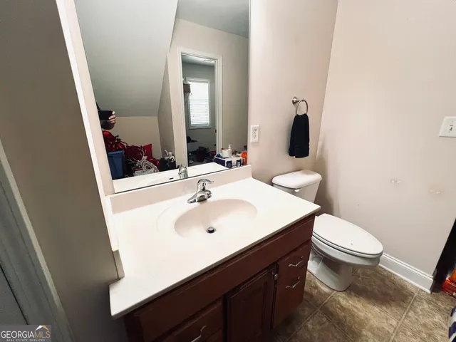a bathroom with a sink toilet and mirror