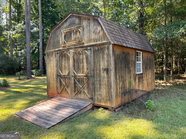 a view of a wooden house with a yard