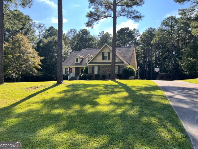 a front view of house with yard and green space