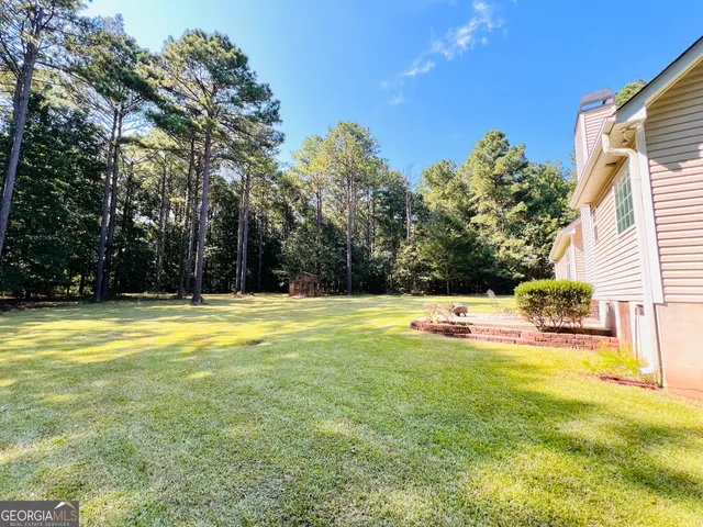 a view of a swimming pool with an outdoor space and seating area