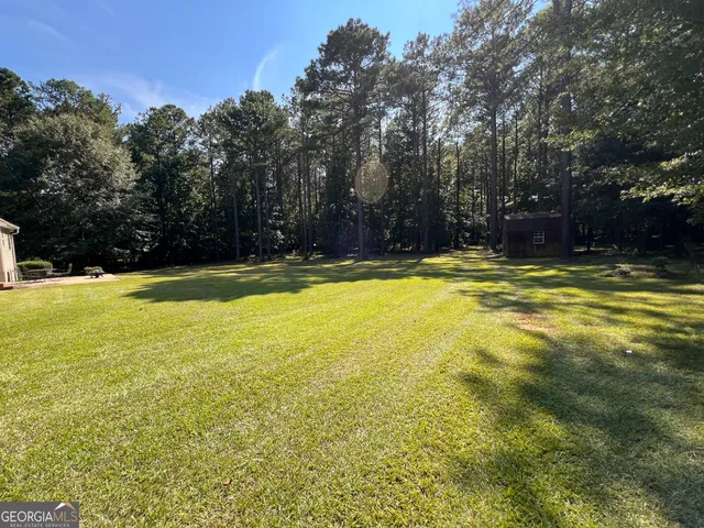 a view of a swimming pool with an outdoor space and seating area