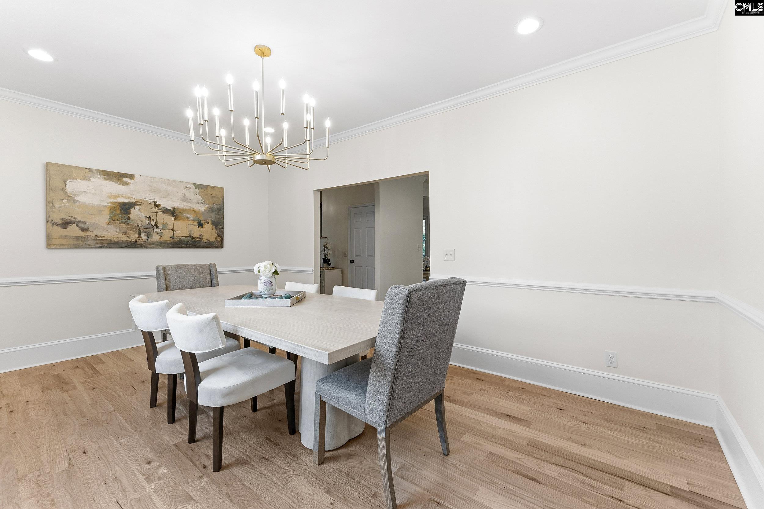 121 Silver Lake Road East Columbia, SC 29223 - Photo 20 of 57 a view of a dining room with furniture a chandelier and wooden floor