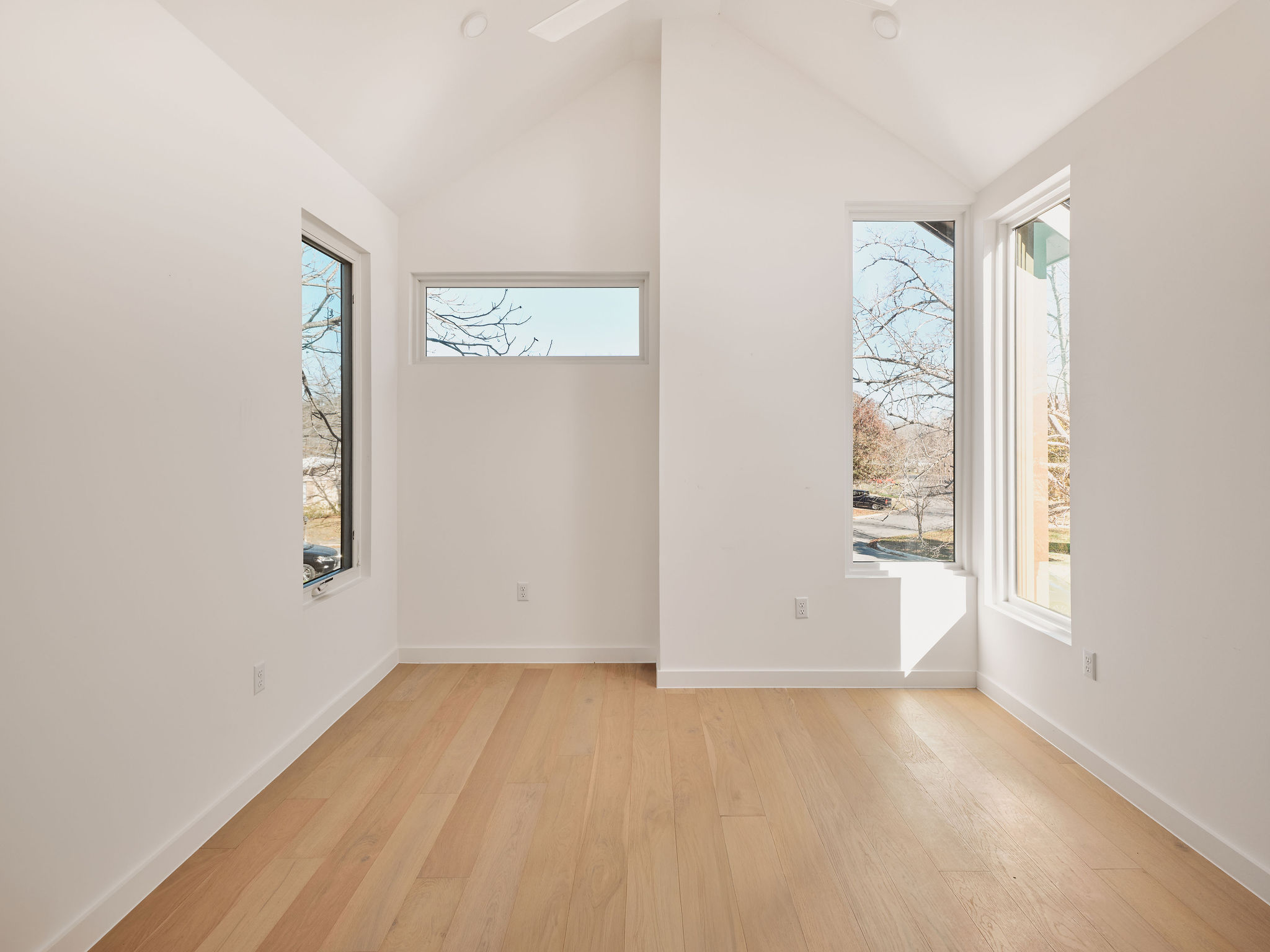 3209 Dolphin Drive, Unit 2 Austin, TX 78704 - Photo 20 of 28 Unfurnished room with light wood-style floors and lofted ceiling