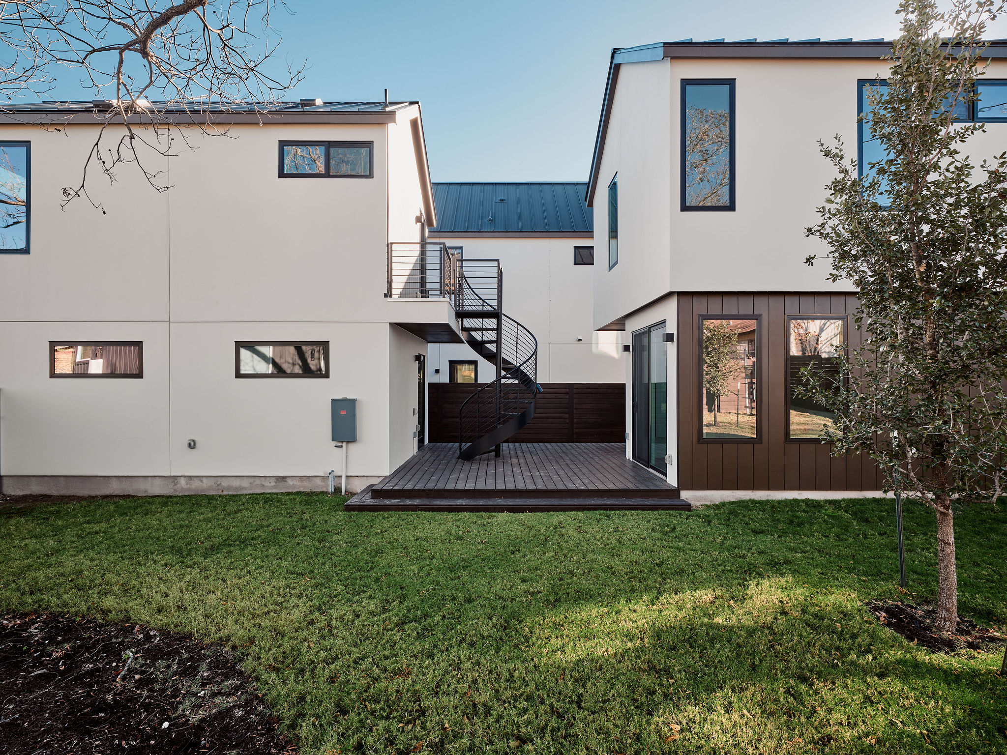 3209 Dolphin Drive, Unit 2 Austin, TX 78704 - Photo 24 of 28 Rear view of property featuring a metal roof, a deck, a lawn, and stairs