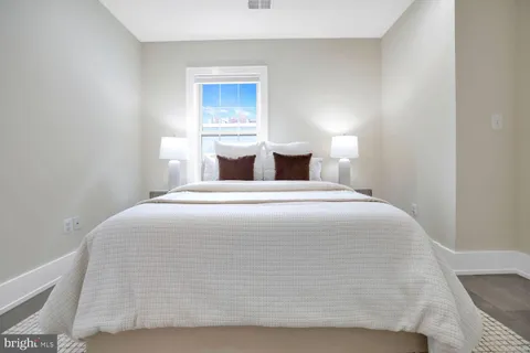 a bedroom with a bed and window