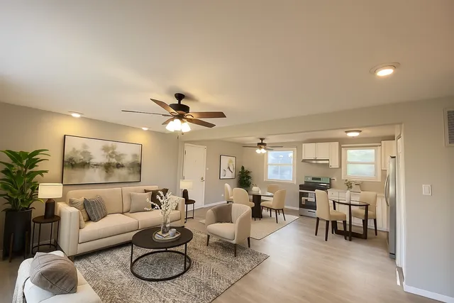 a living room with furniture and a chandelier