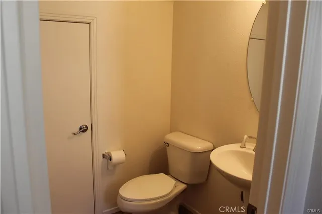 a white toilet sitting next to a shower