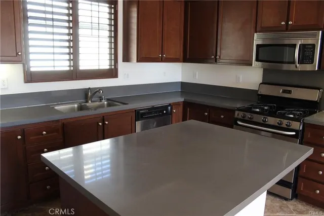 a kitchen with a sink a stove and microwave