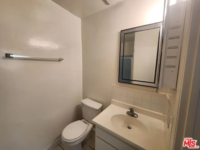 a white toilet sitting next to a bathroom sink