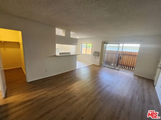 a view of a room with wooden floor and windows