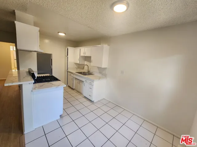 a kitchen with a sink cabinets and appliances