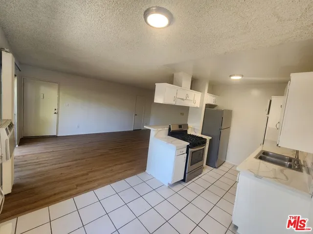 a kitchen with granite countertop a sink and a stove top oven