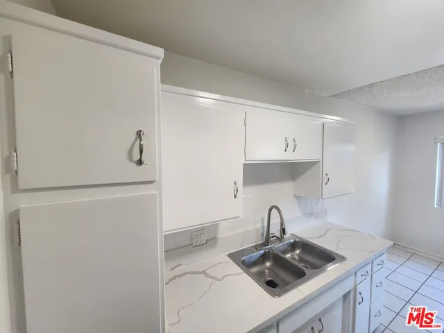 a kitchen with a refrigerator and a sink