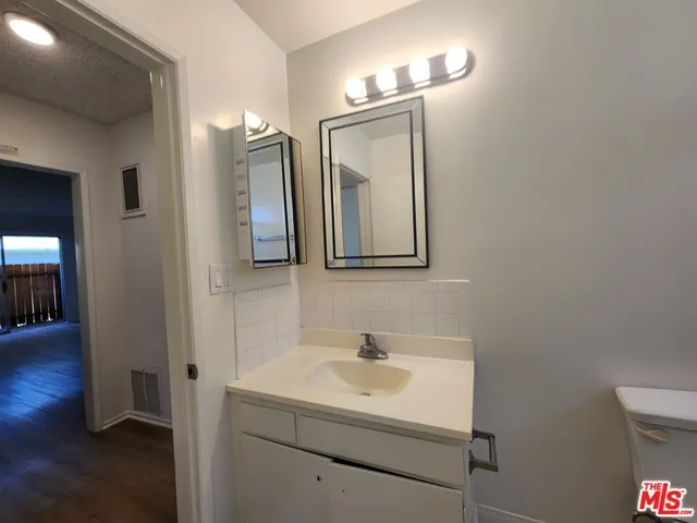 a bathroom with a sink vanity and a mirror