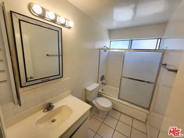 a bathroom with a sink mirror vanity and toilet