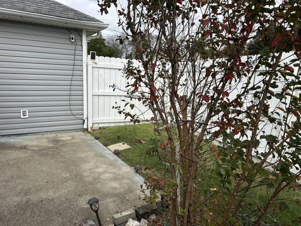 a view of a house with a yard and sitting area