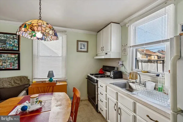a kitchen with stainless steel appliances granite countertop a sink a stove and a wooden cabinets