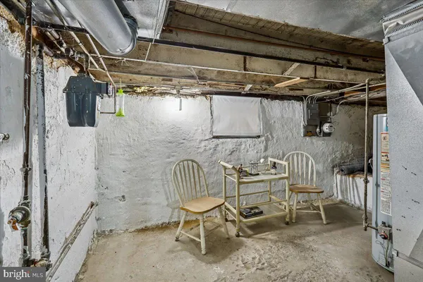 a view of a room with table and chairs