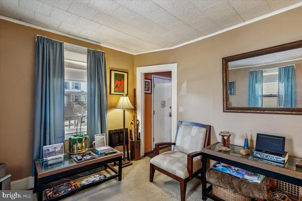 a living room with furniture and a floor to ceiling window