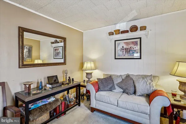 a living room with furniture and a night stand