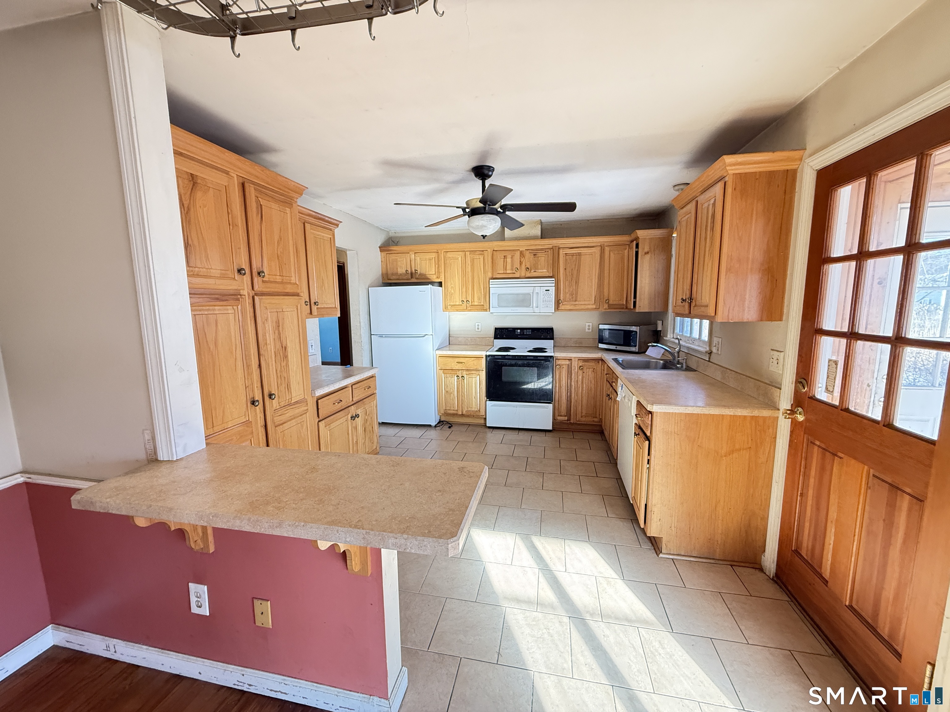 409 Boston Street Guilford, CT 06437 - Photo 12 of 28 a kitchen with stainless steel appliances granite countertop a refrigerator a stove and a sink with granite countertops