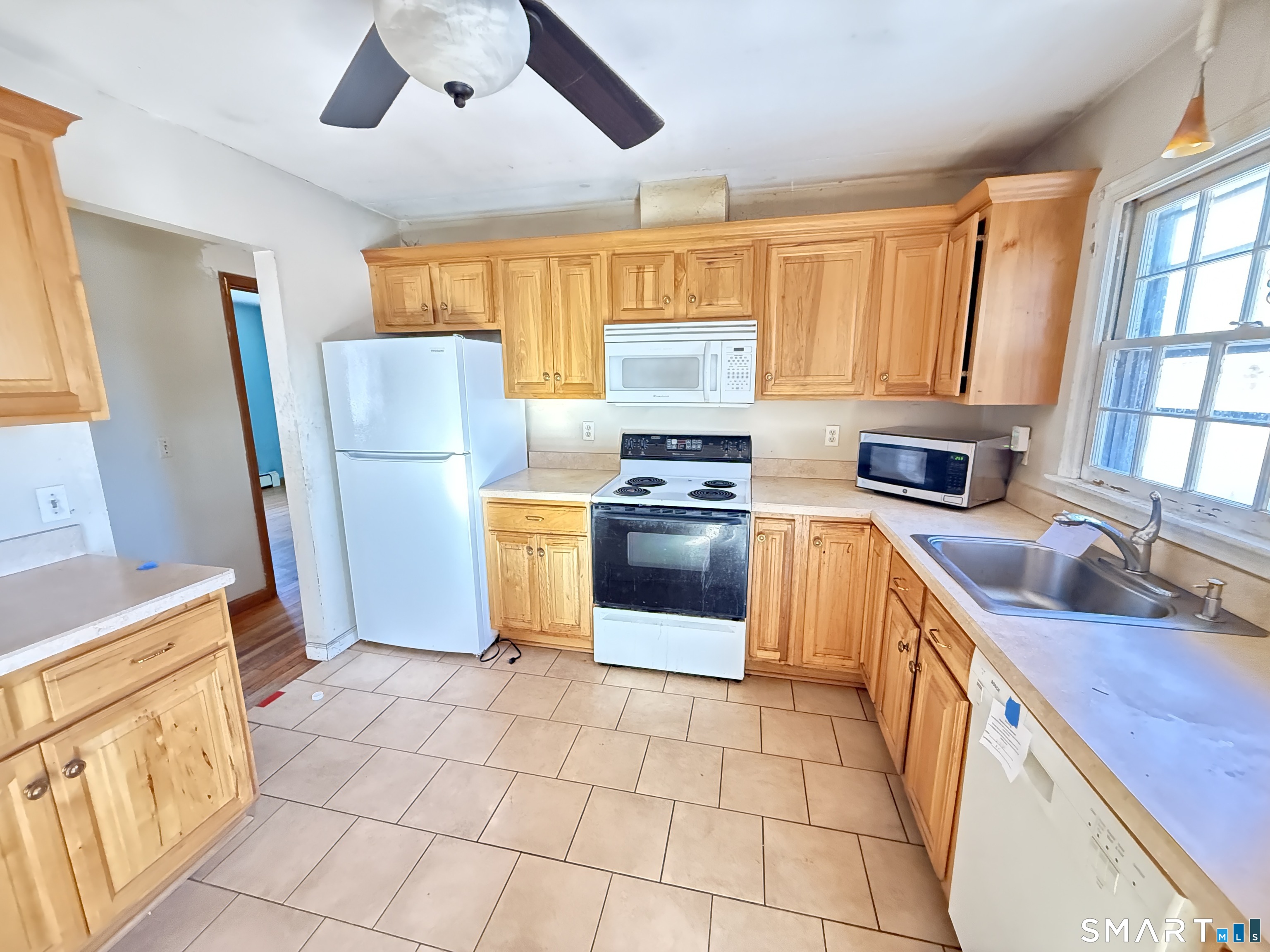 409 Boston Street Guilford, CT 06437 - Photo 14 of 28 a kitchen with a stove a sink and a refrigerator