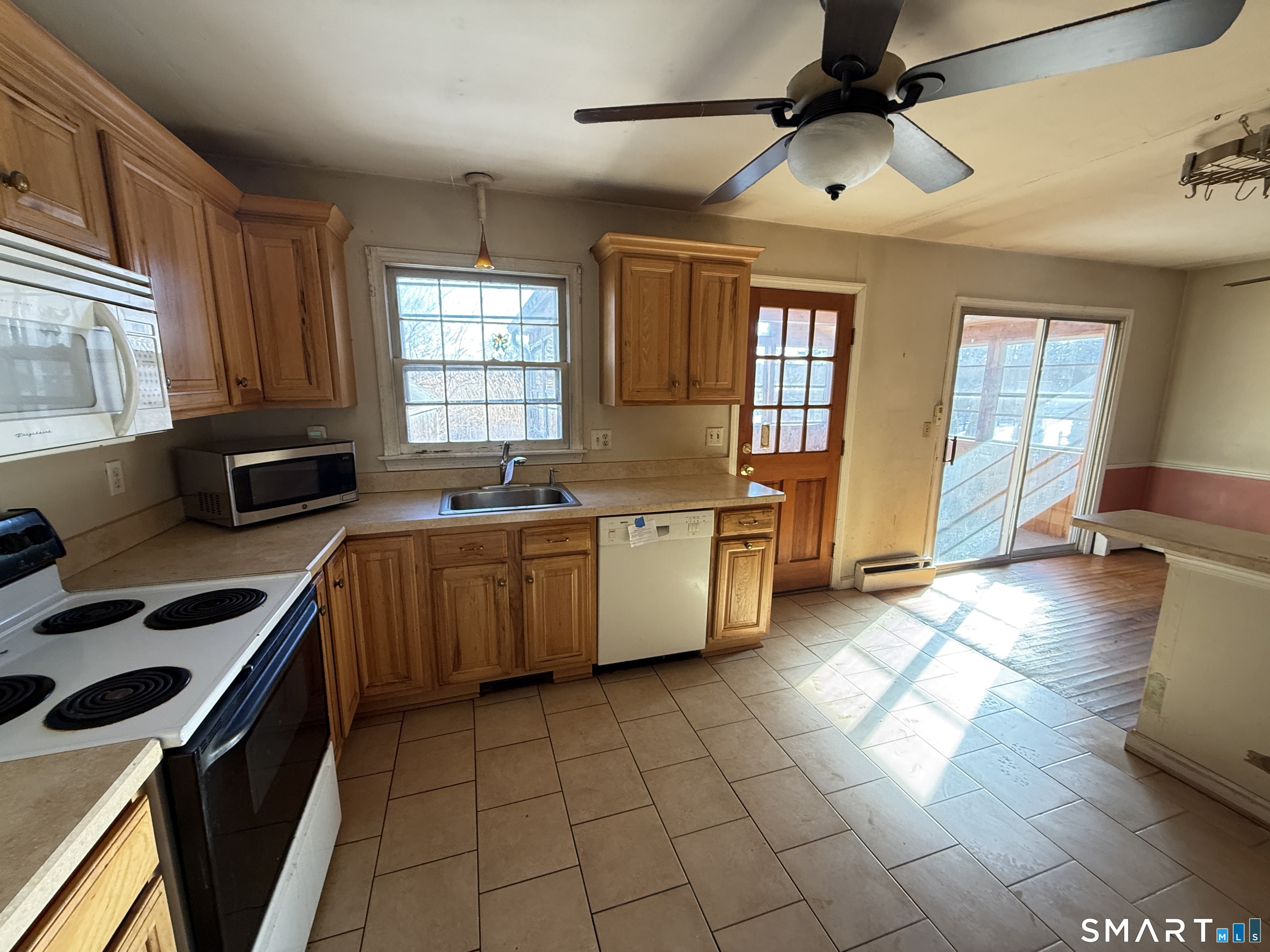 409 Boston Street Guilford, CT 06437 - Photo 15 of 28 a kitchen with a sink a stove and cabinets