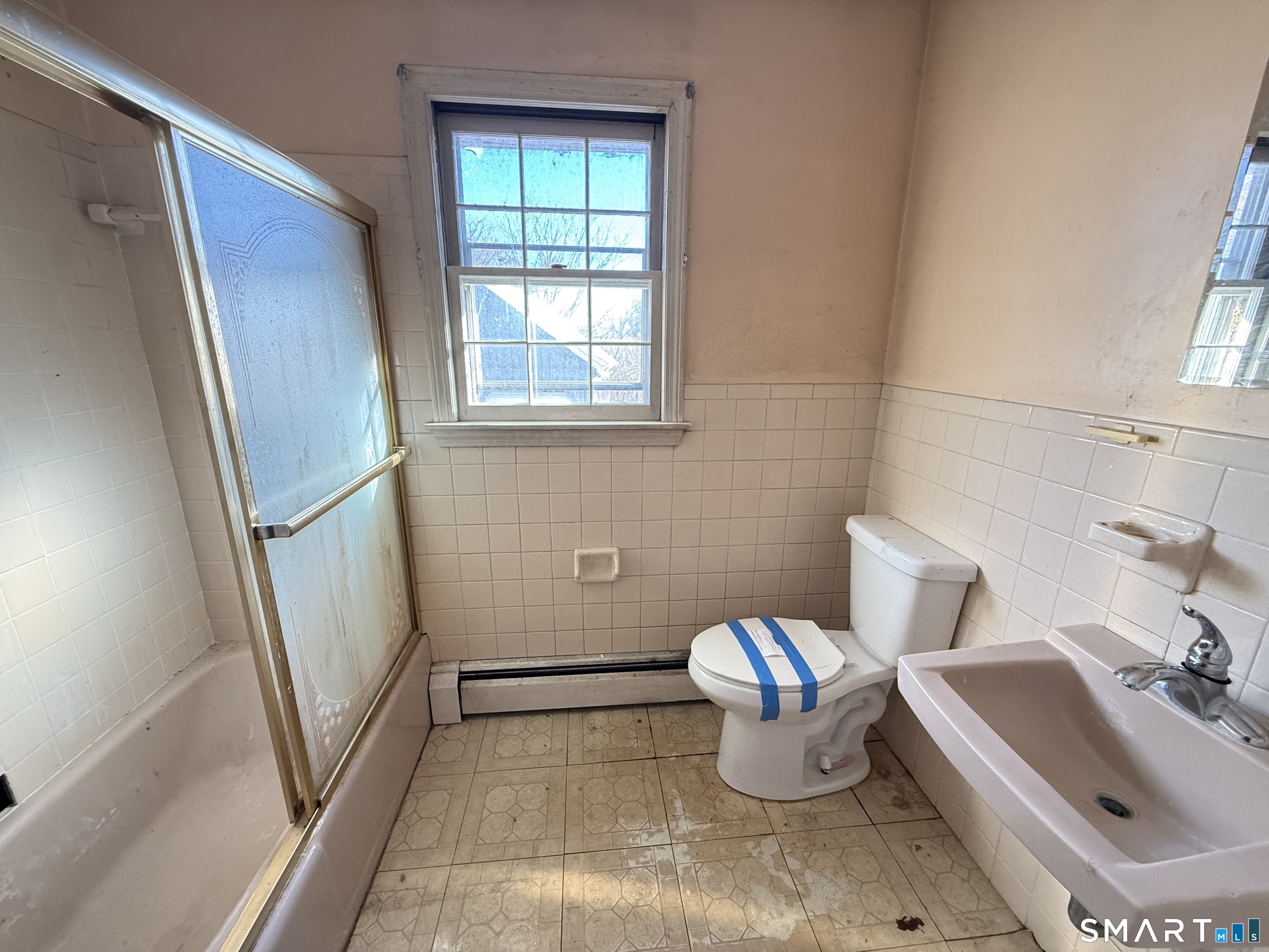 409 Boston Street Guilford, CT 06437 - Photo 19 of 28 a bathroom with a sink and a mirror