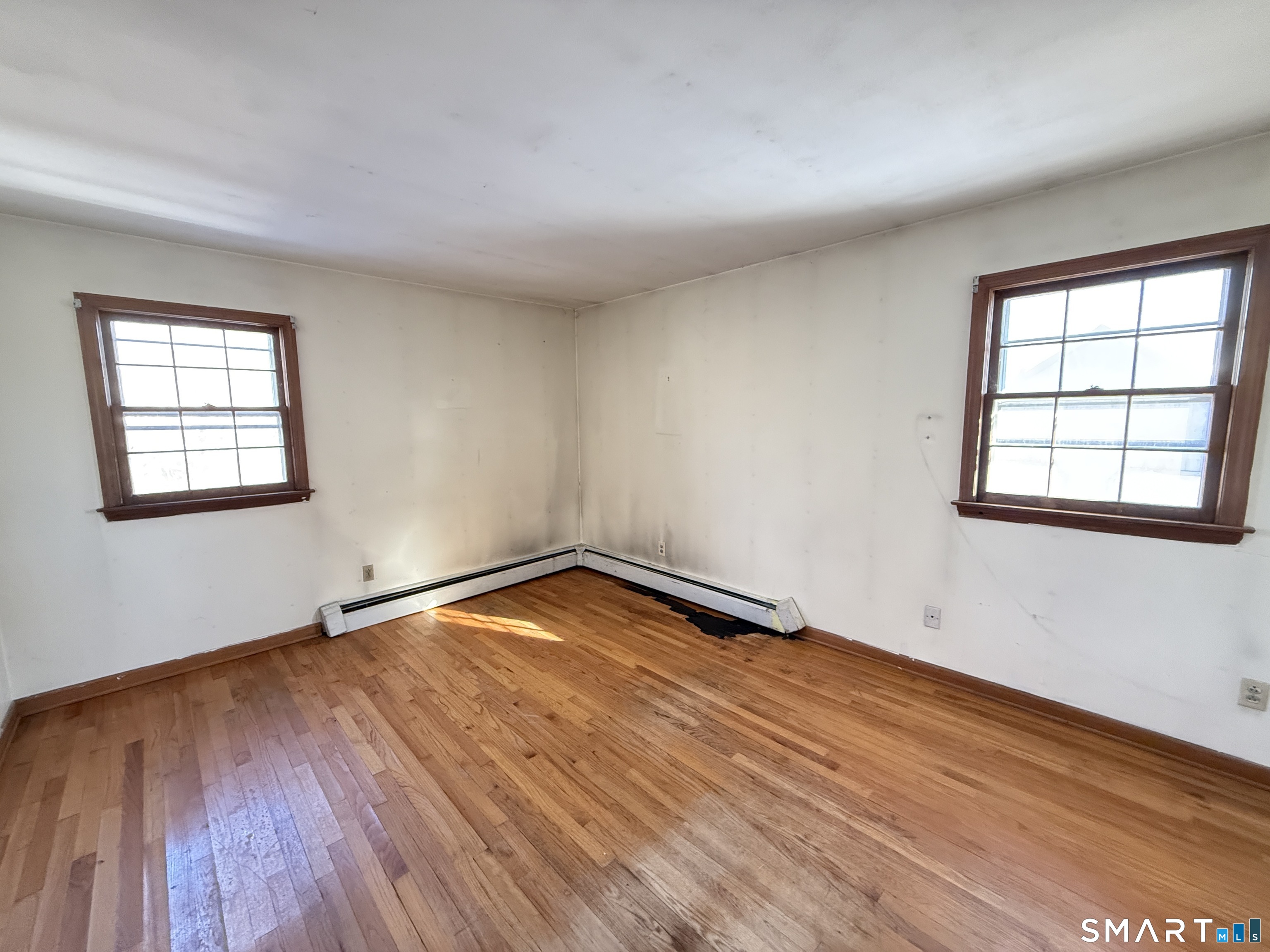 409 Boston Street Guilford, CT 06437 - Photo 20 of 28 an empty room with wooden floor and windows