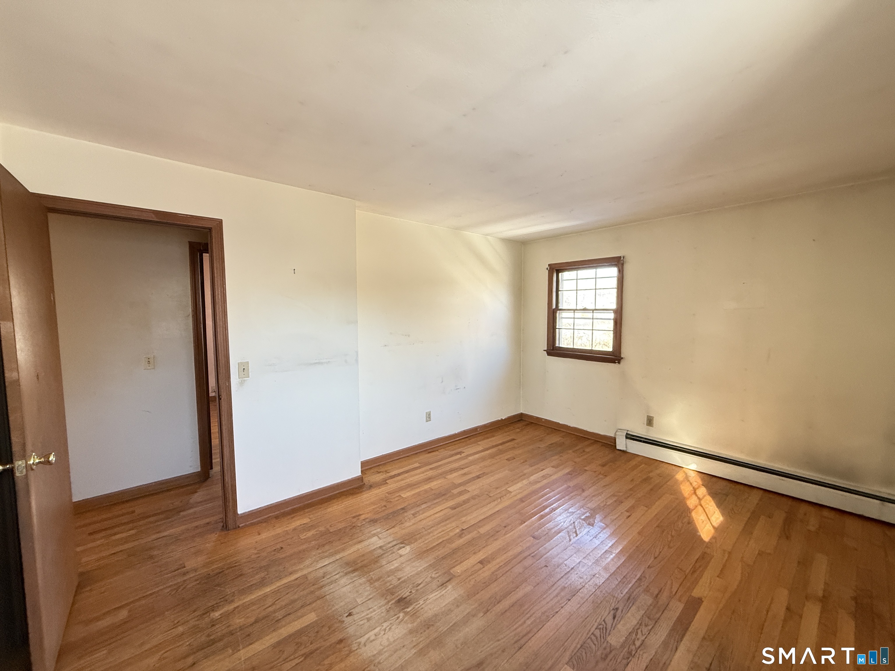 409 Boston Street Guilford, CT 06437 - Photo 21 of 28 an empty room with wooden floor and windows