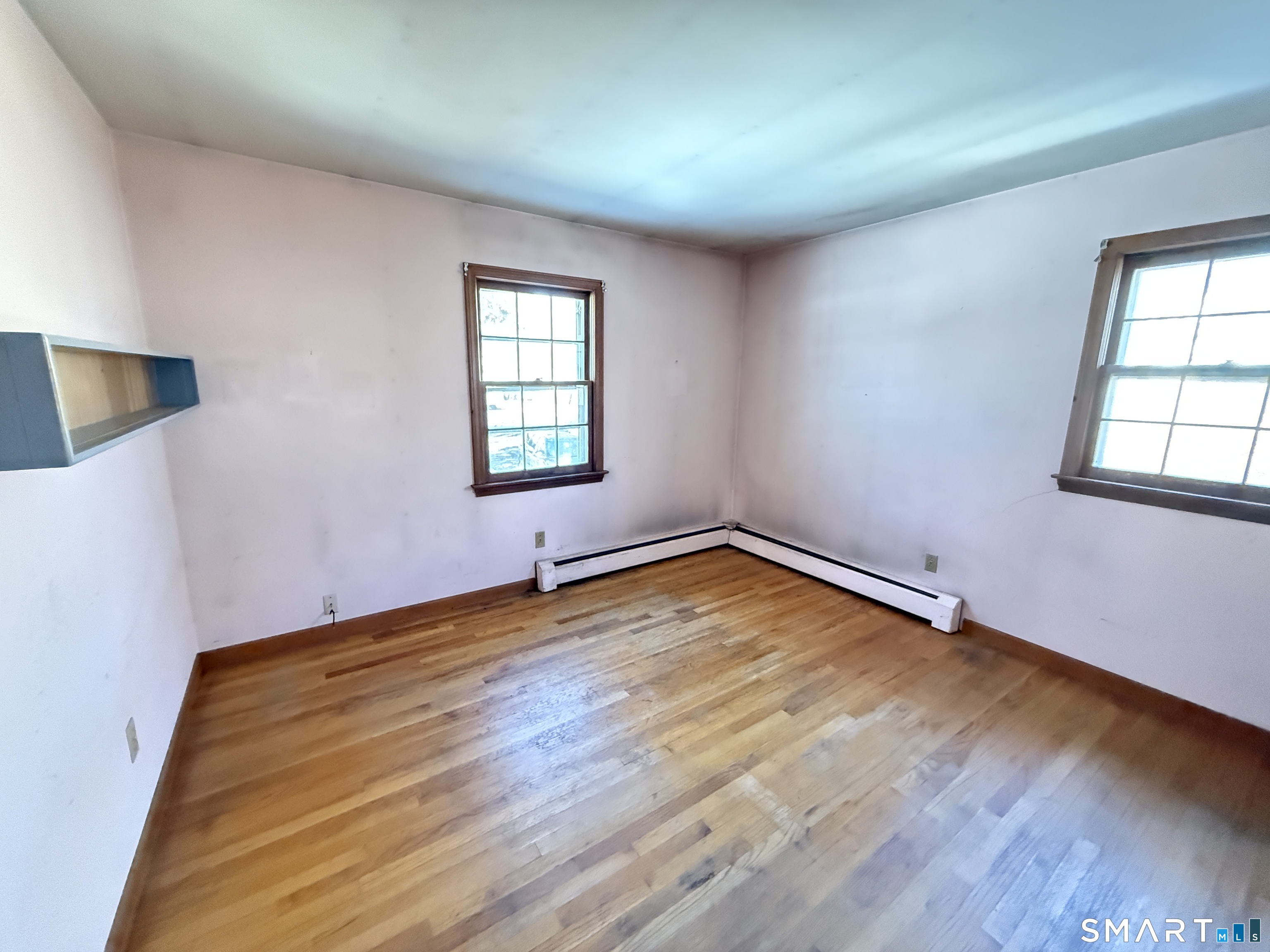 409 Boston Street Guilford, CT 06437 - Photo 22 of 28 an empty room with wooden floor and windows