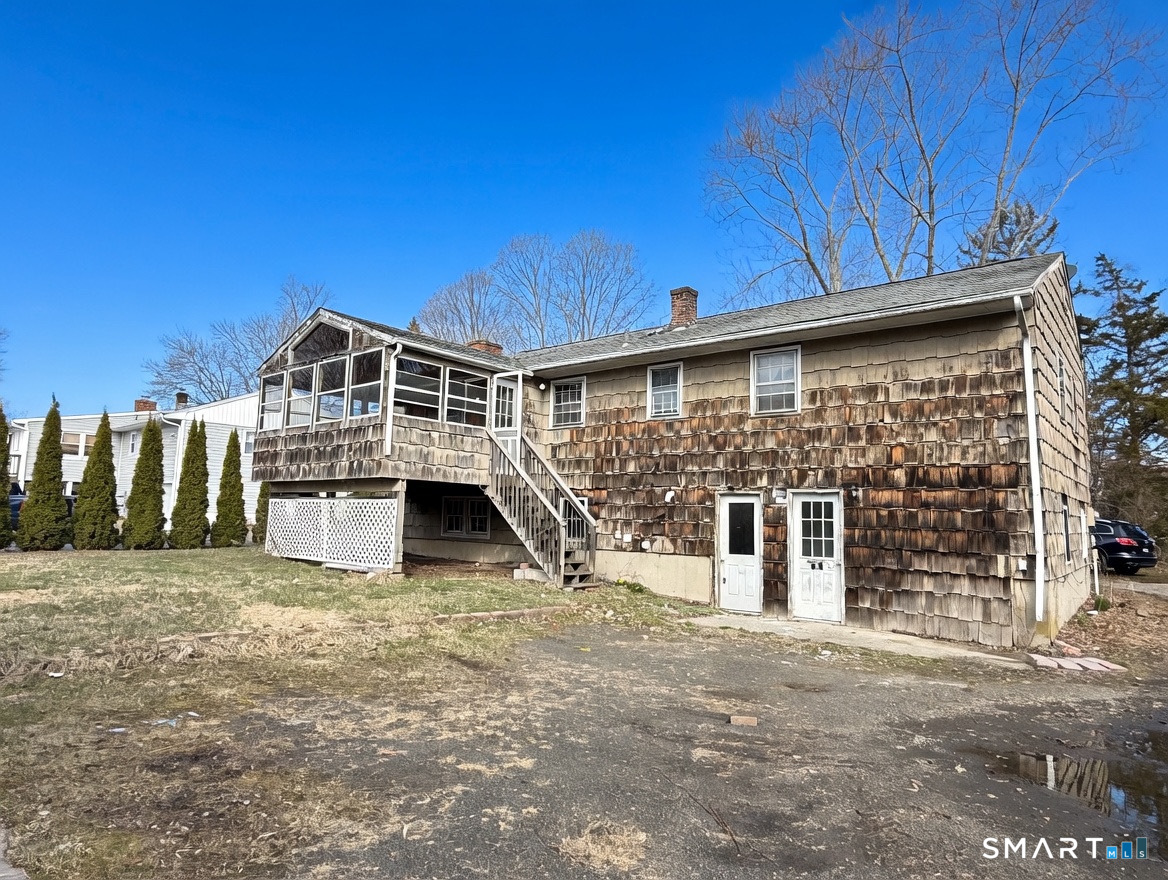 409 Boston Street Guilford, CT 06437 - Photo 4 of 28 a view of a house with a large window and wooden fence