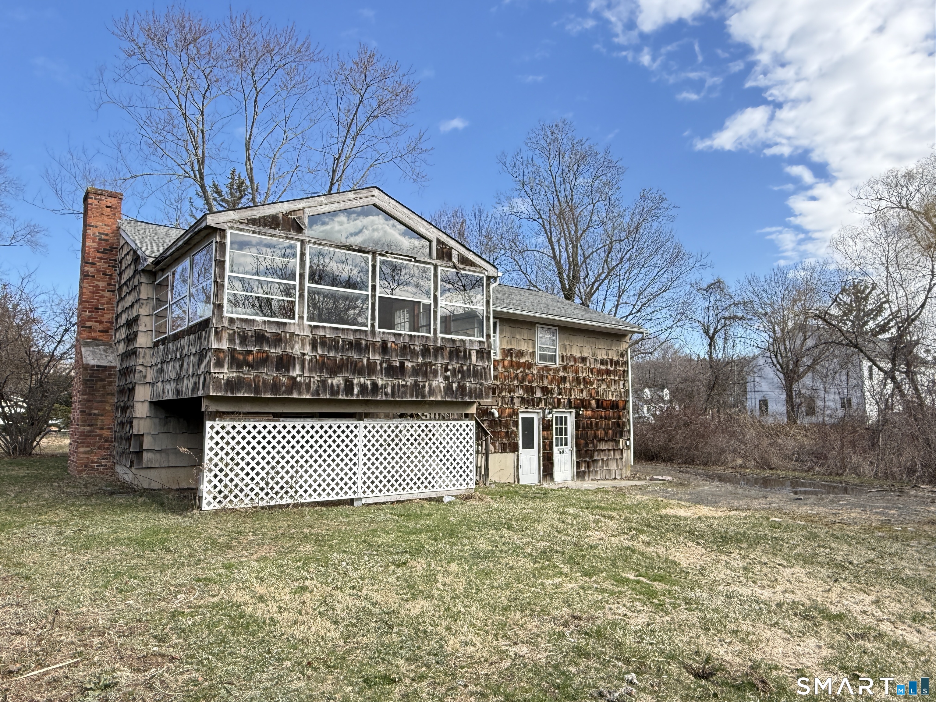 409 Boston Street Guilford, CT 06437 - Photo 5 of 28 a front view of a house with a yard