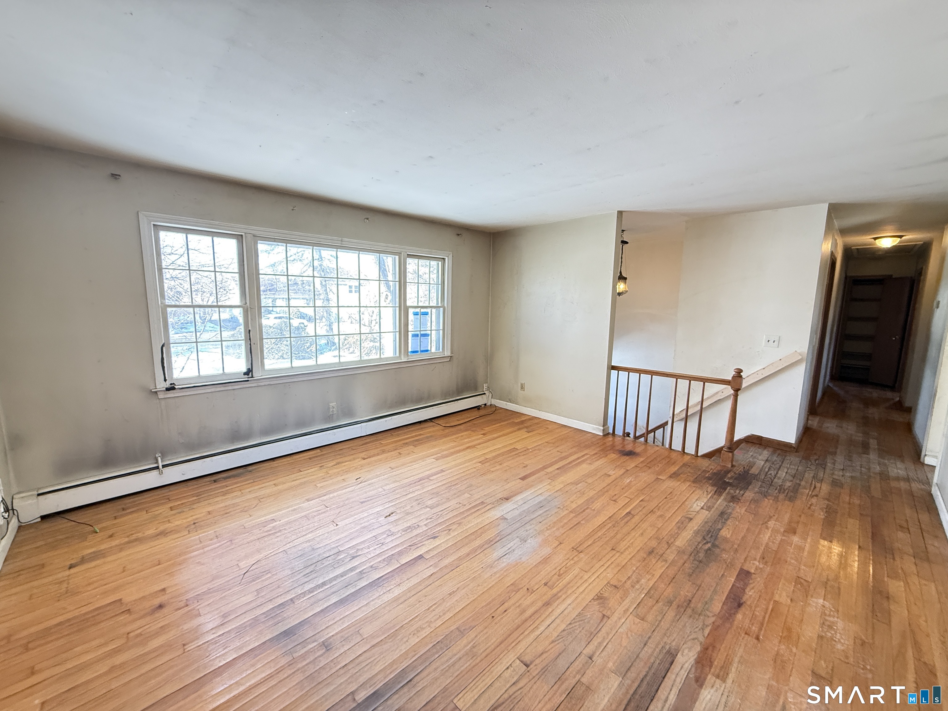 409 Boston Street Guilford, CT 06437 - Photo 8 of 28 an empty room with wooden floor and windows