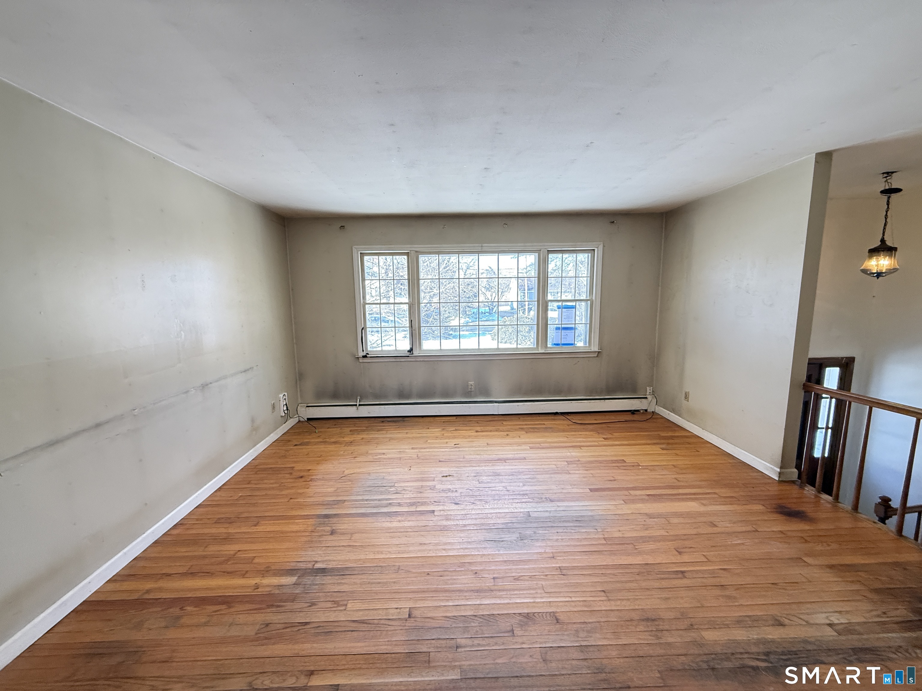 409 Boston Street Guilford, CT 06437 - Photo 9 of 28 a view of empty room with wooden floor and fan