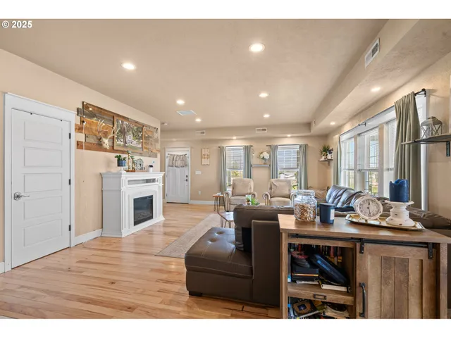 a living room with furniture kitchen view and a fireplace