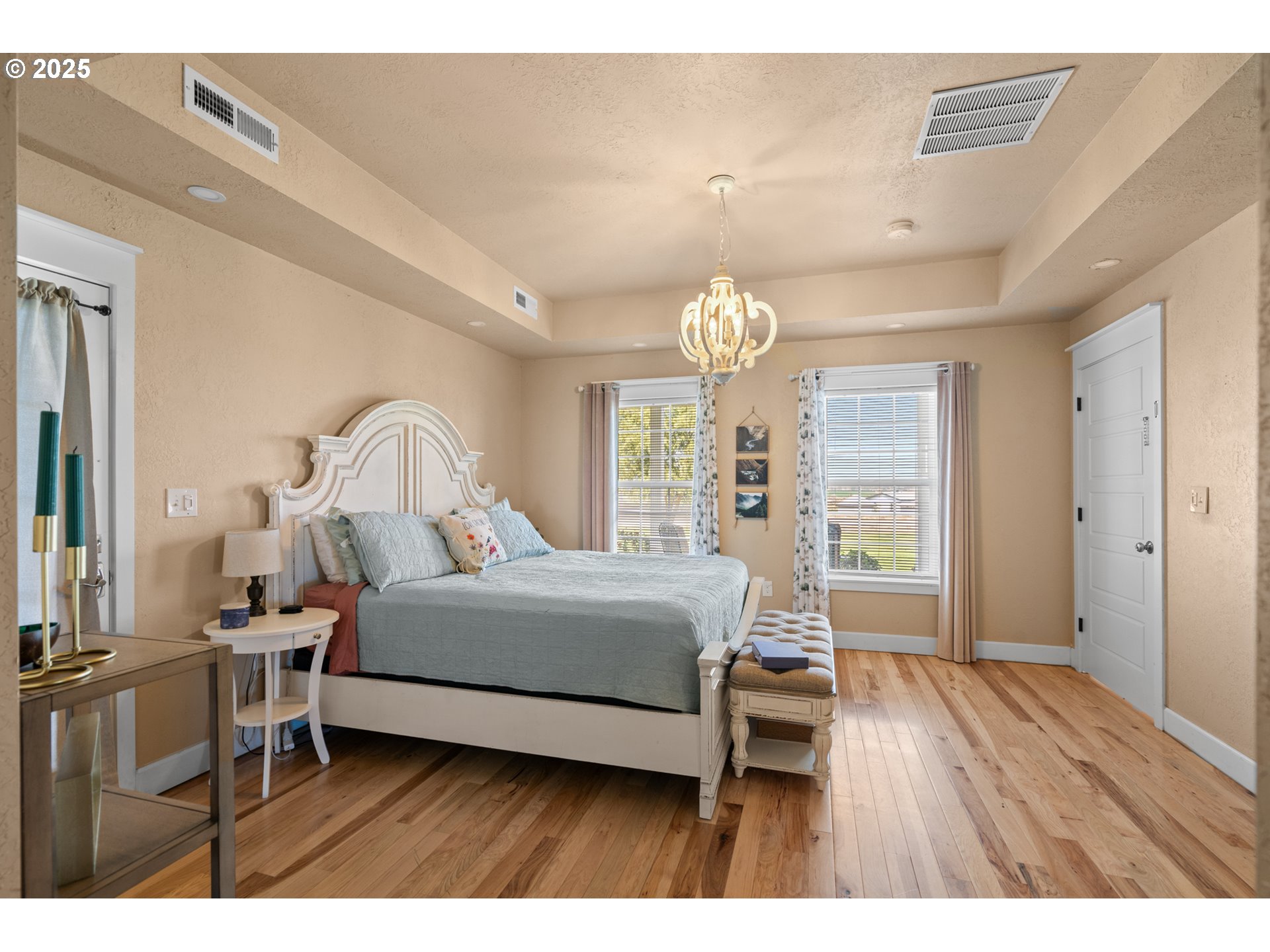 31946 Sun Rdg Lane Hermiston, OR 97838 - Photo 14 of 36 a bedroom with a bed and a chandelier