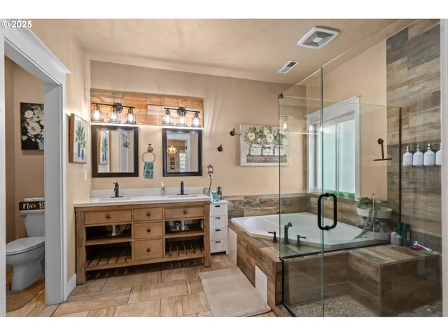 a bathroom with a double vanity sink a mirror and a shower