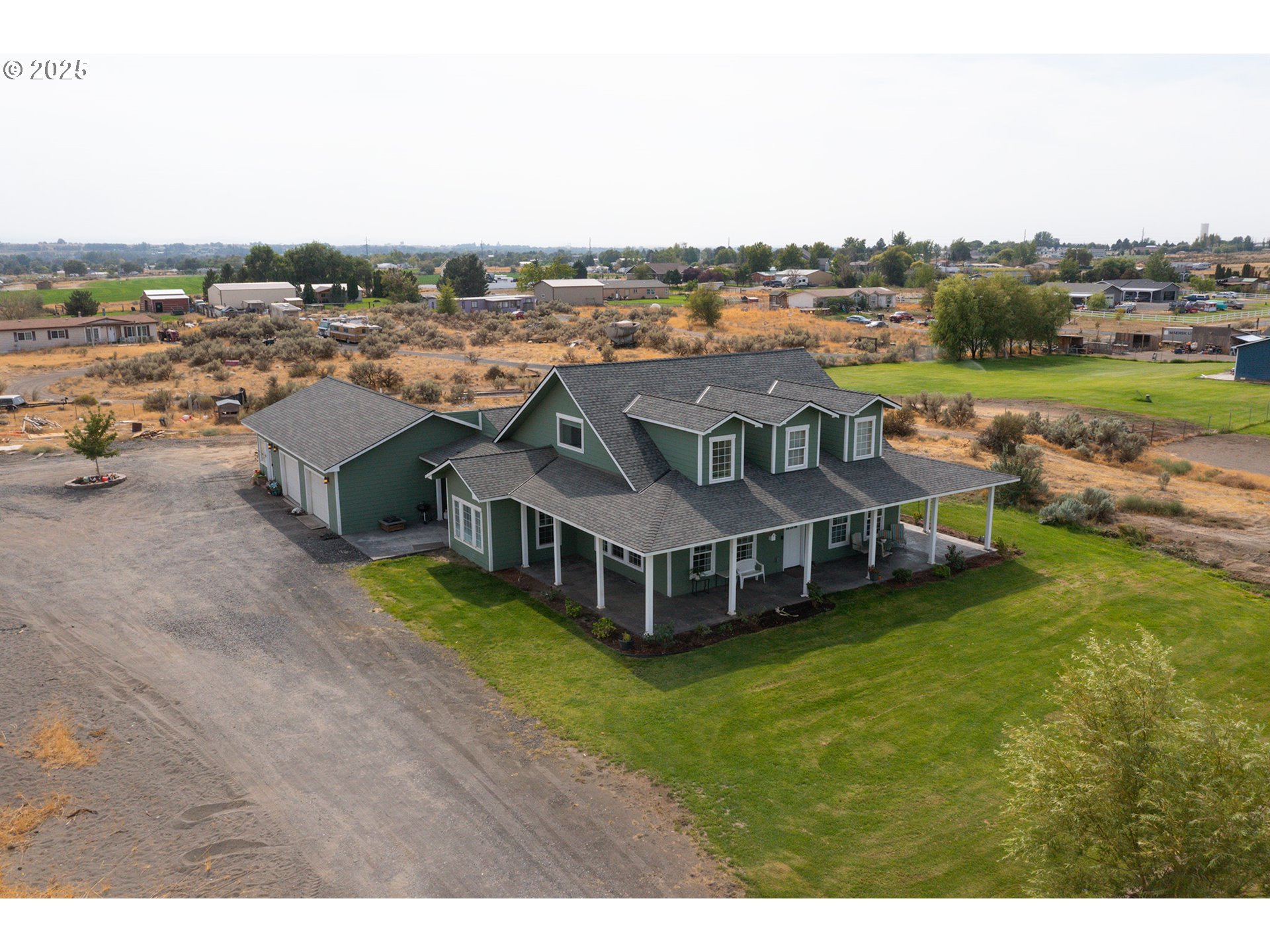 31946 Sun Rdg Lane Hermiston, OR 97838 - Photo 3 of 36 a view of a house with a big yard and large trees