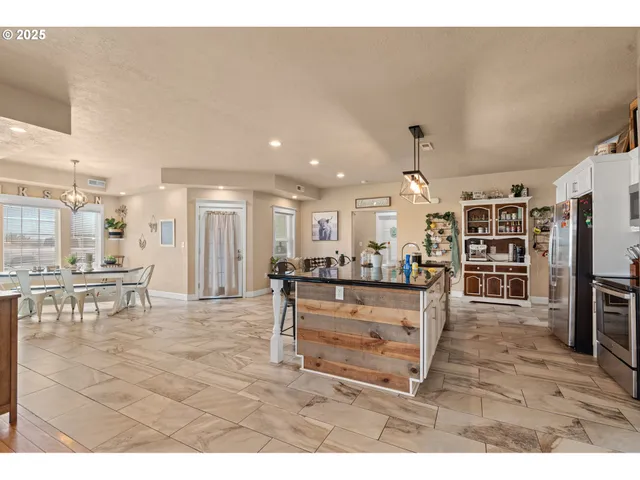a living room with lots of furniture and kitchen view