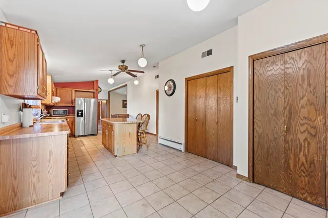 a view of a kitchen with furniture and wooden floor