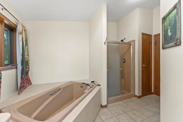 a bathroom with a tub and shower