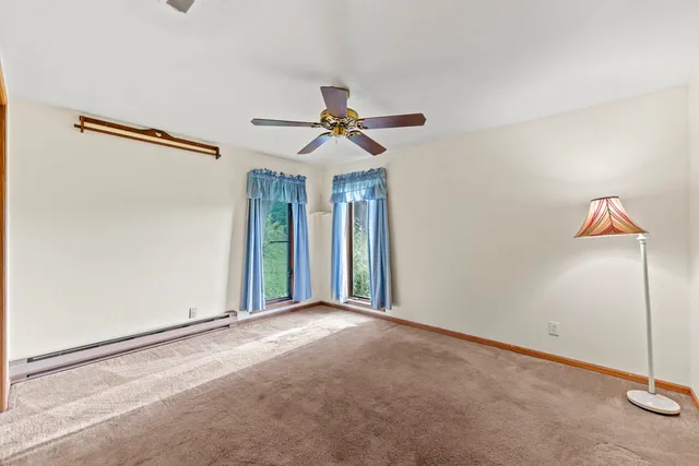 a view of a livingroom with a ceiling fan and window