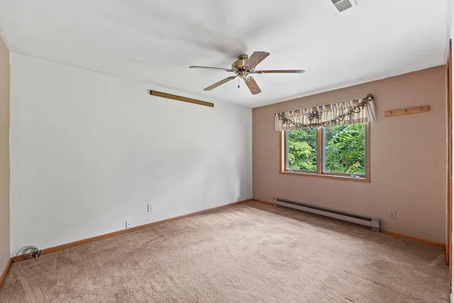 a view of room with window and ceiling fan
