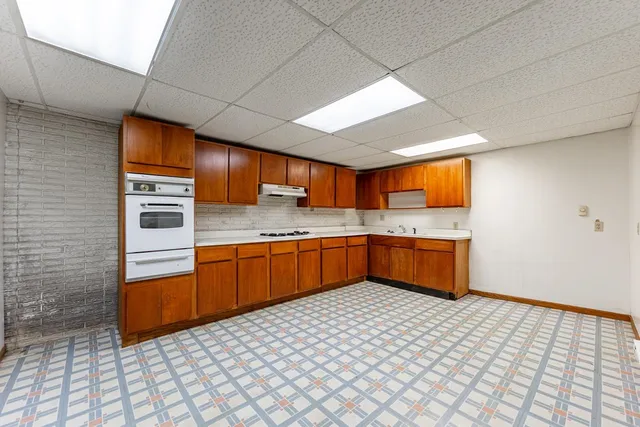 a kitchen with stainless steel appliances a sink and cabinets