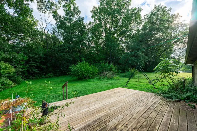 a view of a backyard with wooden fence